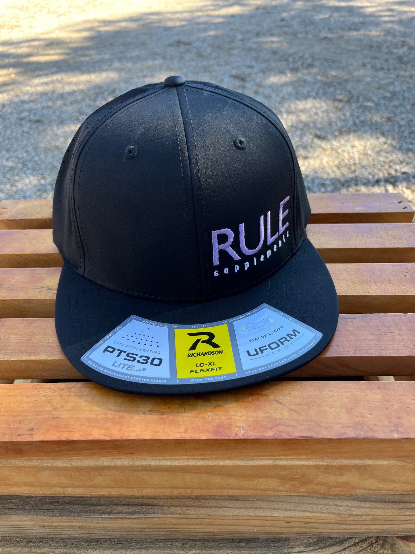 Rule Supplements Hat with Purple Stitching on Left Side
