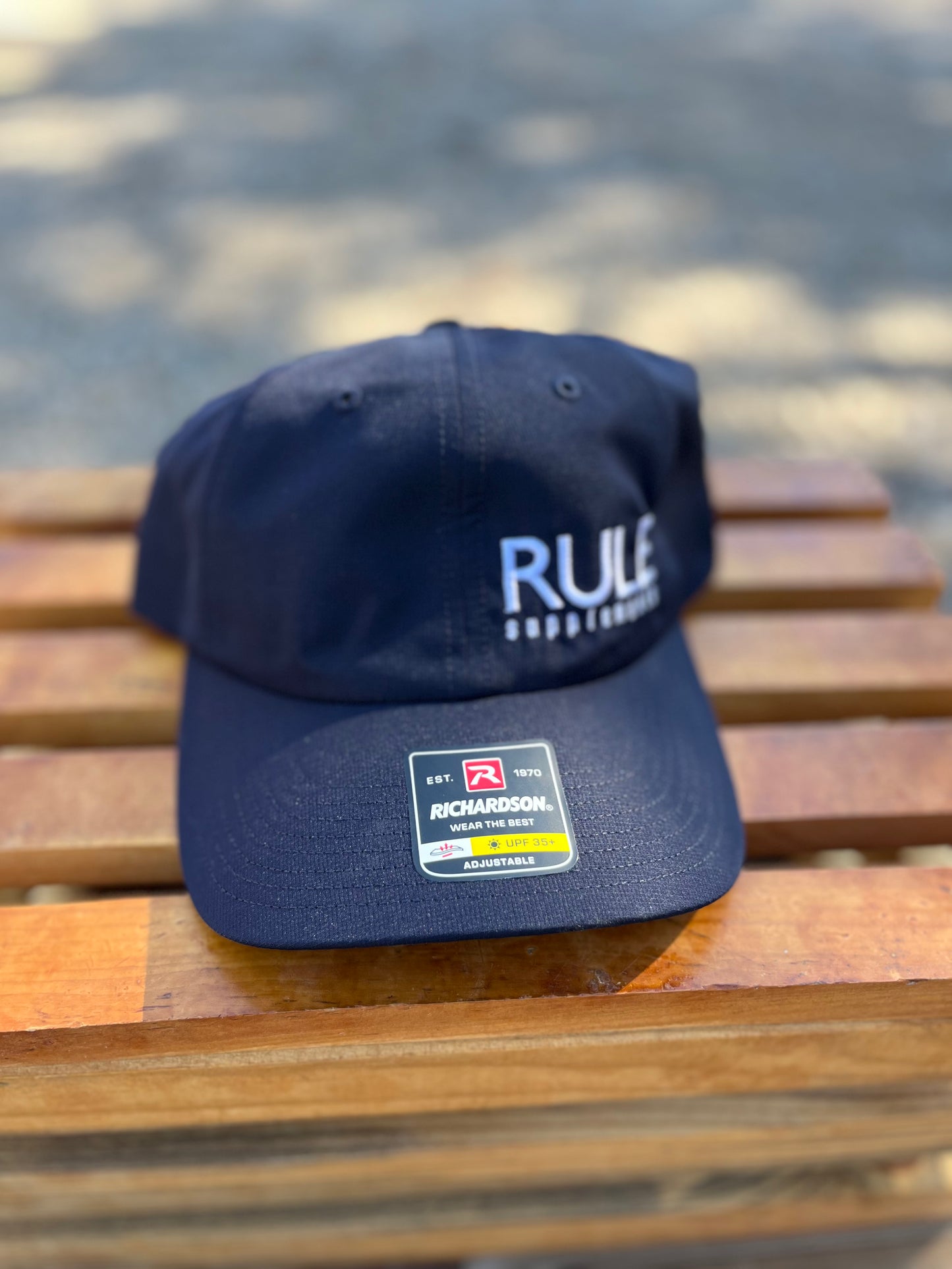 Rule Supplements Navy Hat with White Writing